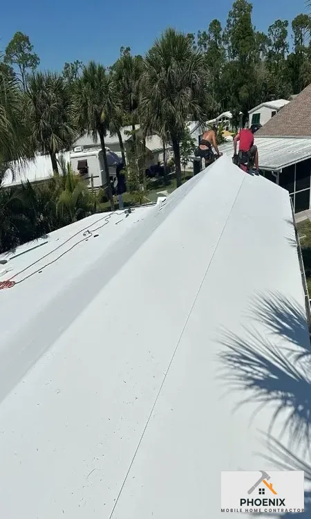 Seamless white roof coating installation on manufactured home to increase energy efficiency in Arizona
